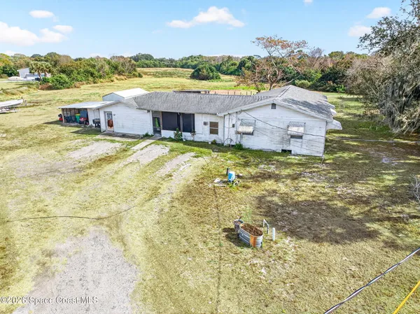 a aerial view of a house with a yard and lake view