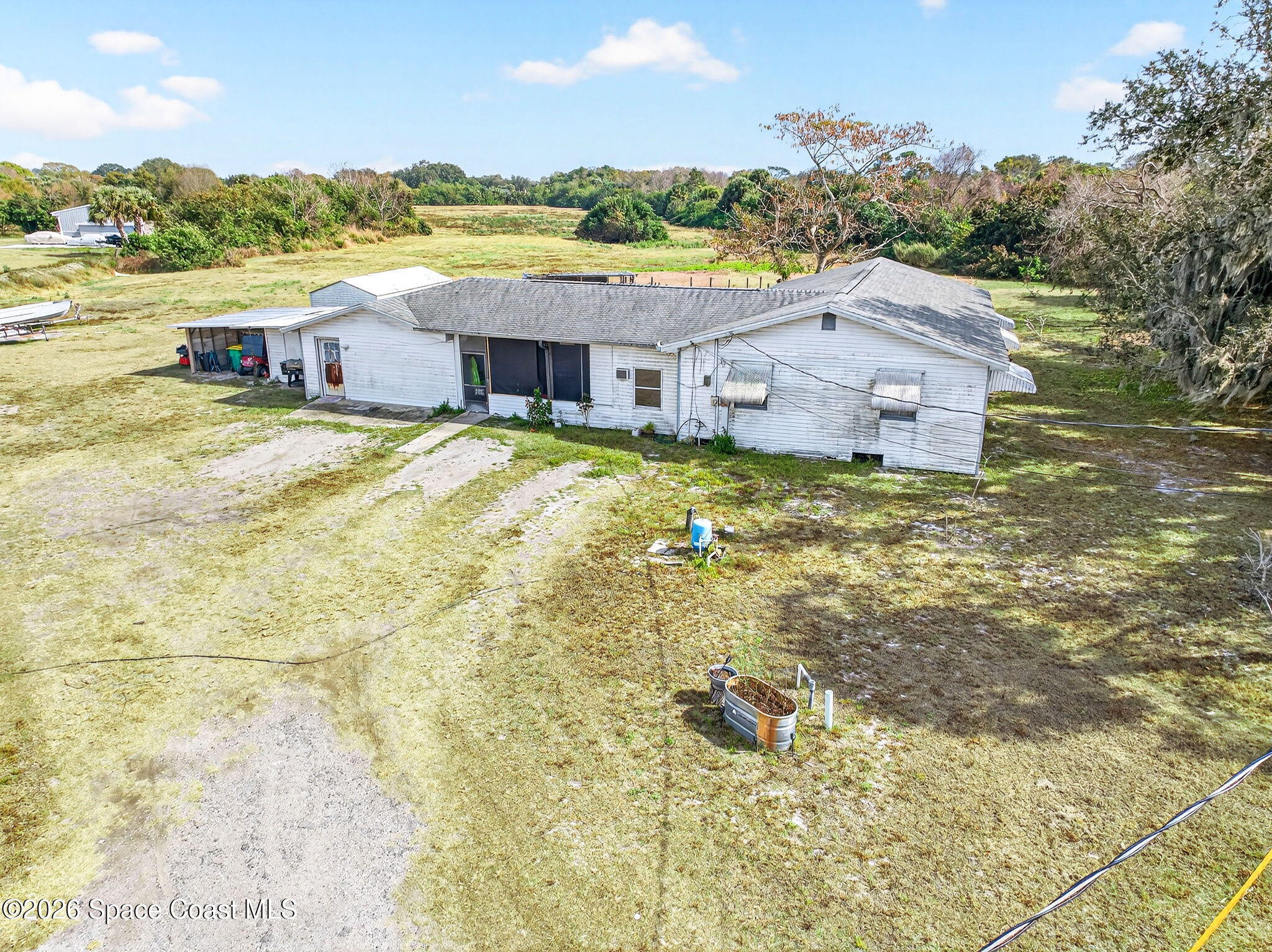 a aerial view of a house with a yard and lake view