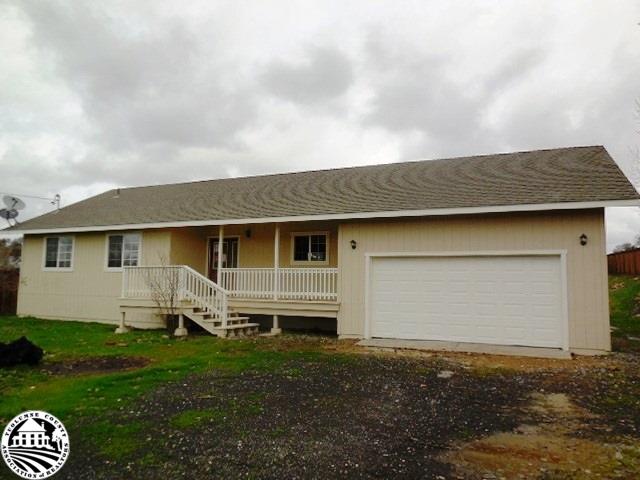 2093 Quail Hill Road Copperopolis, CA 95228 - Photo 1 of 14 a front view of a house with a garden and yard