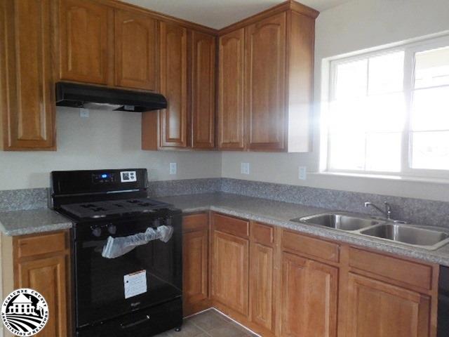 2093 Quail Hill Road Copperopolis, CA 95228 - Photo 4 of 14 a kitchen with stainless steel appliances granite countertop a sink stove and cabinets