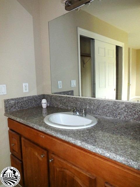 2093 Quail Hill Road Copperopolis, CA 95228 - Photo 6 of 14 a bathroom with a granite countertop sink and a mirror
