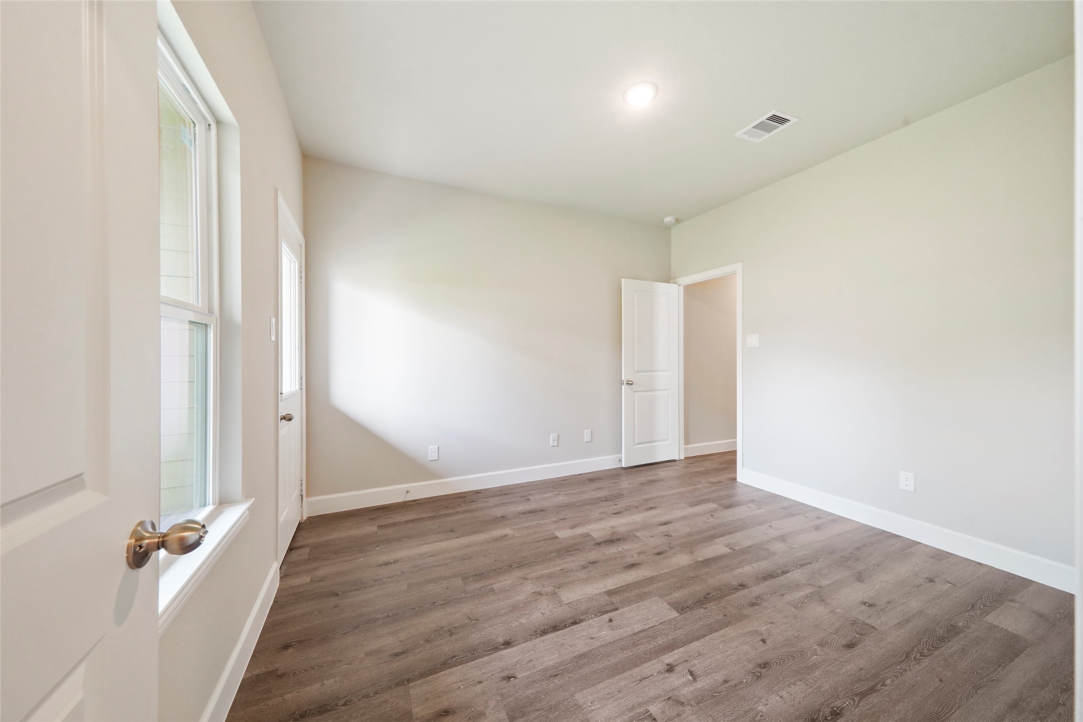 412-414 Avenue H Conroe, TX 77301 - Photo 21 of 25 an empty room with wooden floor and a window