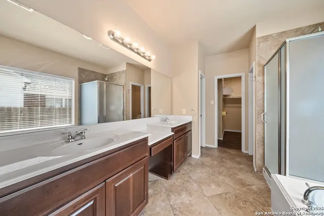 a spacious bathroom with a sink a tub and a mirror