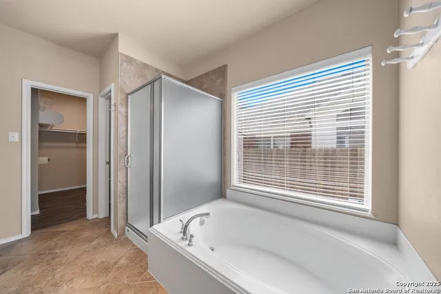 a bathroom with a bathtub and a shower