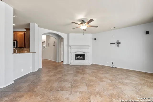 a view of empty room with a fireplace