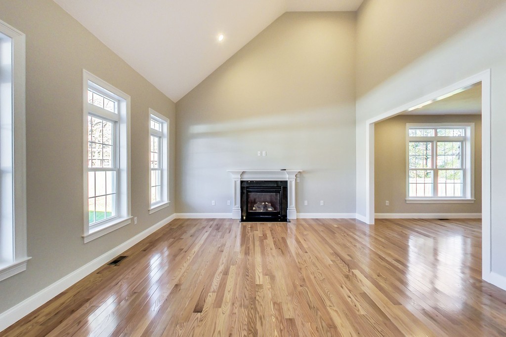 38 Cherry Street, Unit B Hudson, MA 01749 - Photo 11 of 38 wooden floor fireplace and windows in an empty room