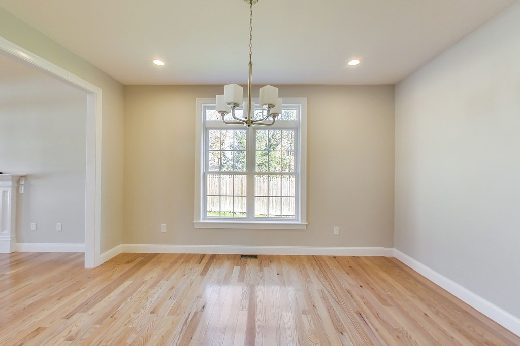 38 Cherry Street, Unit B Hudson, MA 01749 - Photo 13 of 38 a view of an empty room with wooden floor and a window