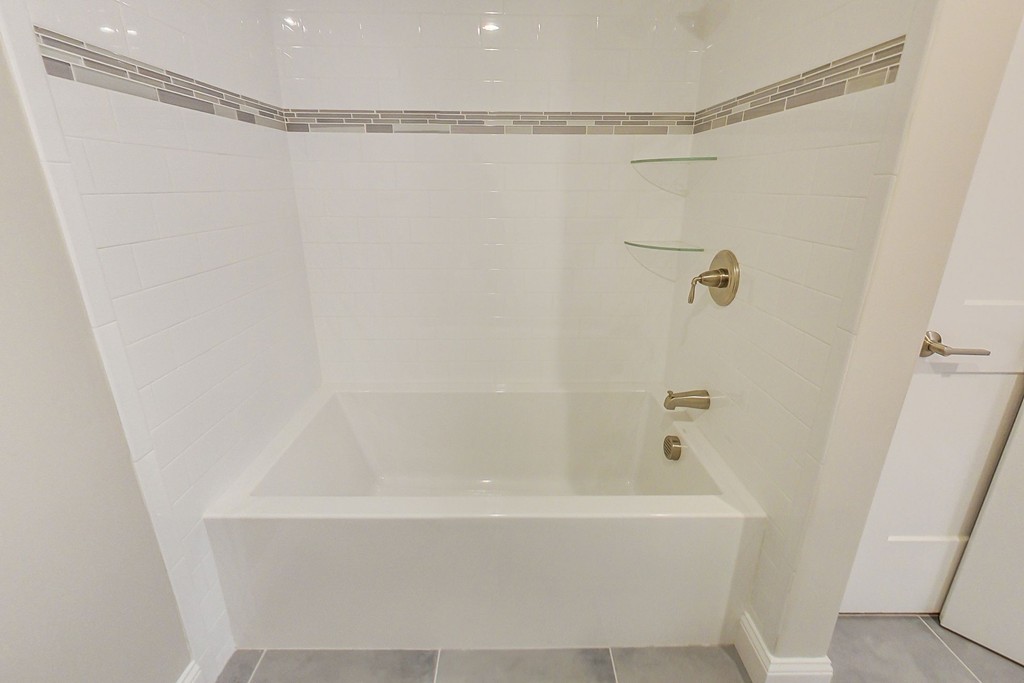 38 Cherry Street, Unit B Hudson, MA 01749 - Photo 17 of 38 a bathroom with a shower and a bath tub