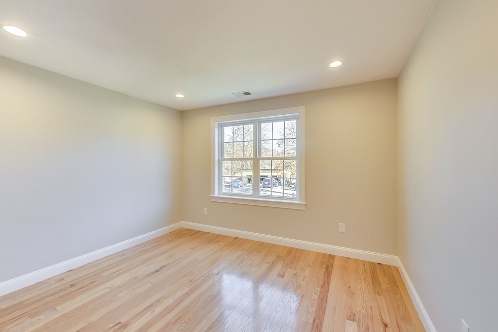 38 Cherry Street, Unit B Hudson, MA 01749 - Photo 20 of 38 a view of an empty room with wooden floor and a window