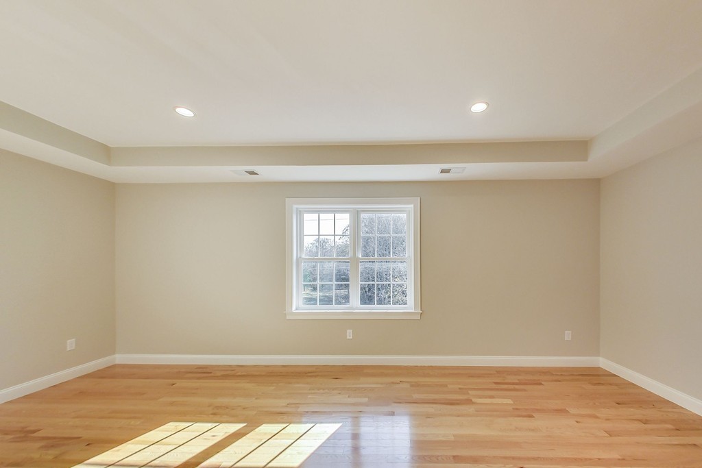 38 Cherry Street, Unit B Hudson, MA 01749 - Photo 23 of 38 an empty room with wooden floor and windows