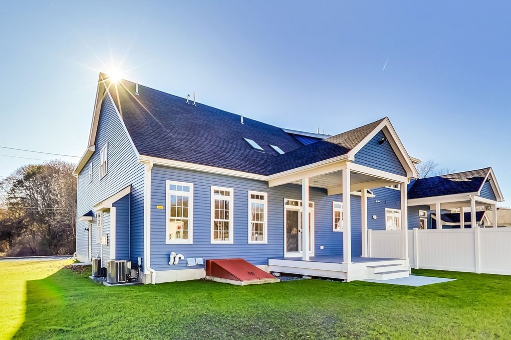 38 Cherry Street, Unit B Hudson, MA 01749 - Photo 31 of 38 front view of a house with a yard