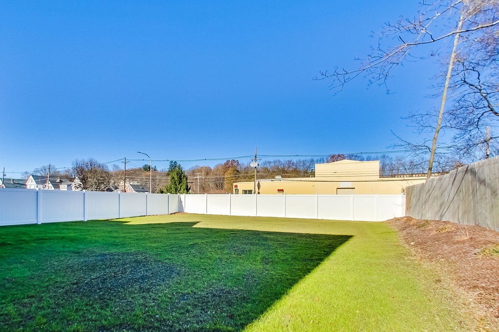 38 Cherry Street, Unit B Hudson, MA 01749 - Photo 35 of 38 a view of a lake with a big yard