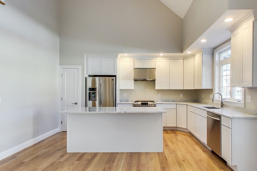 38 Cherry Street, Unit B Hudson, MA 01749 - Photo 7 of 38 a kitchen with stainless steel appliances a sink a stove a refrigerator and cabinets