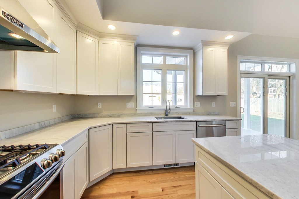 38 Cherry Street, Unit B Hudson, MA 01749 - Photo 8 of 38 a kitchen with a sink stove and cabinets