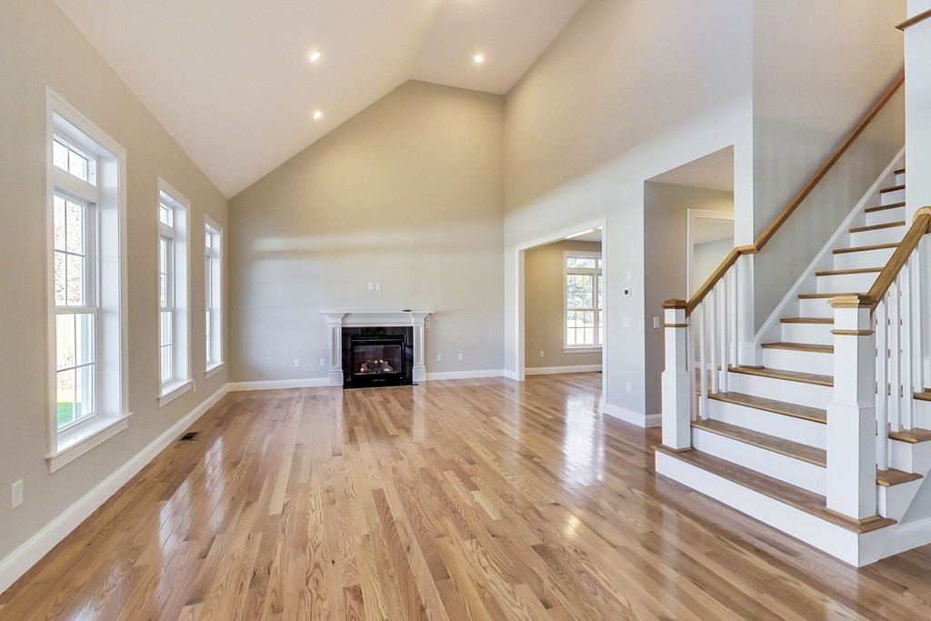 38 Cherry Street, Unit B Hudson, MA 01749 - Photo 10 of 38 wooden floor in an empty room with a fireplace