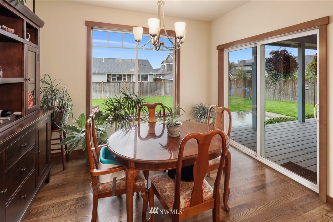 804 Red Maple Loop Everson, WA 98247 - Photo 11 of 40 a dining room with furniture a chandelier and wooden floor