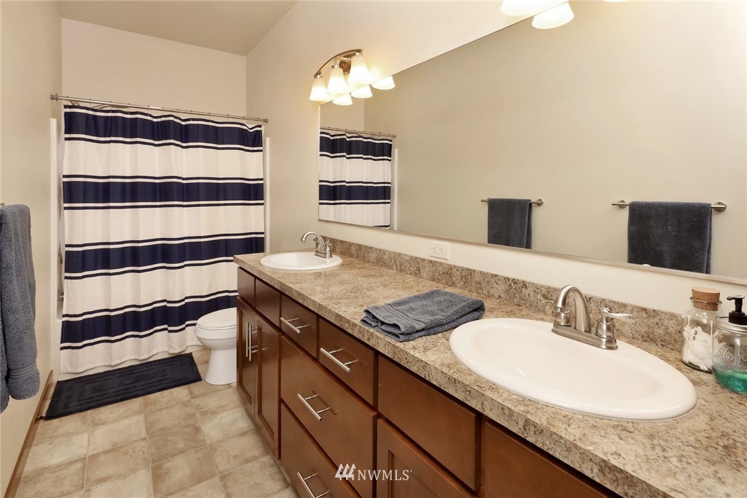 804 Red Maple Loop Everson, WA 98247 - Photo 20 of 40 a bathroom with a granite countertop sink and a mirror