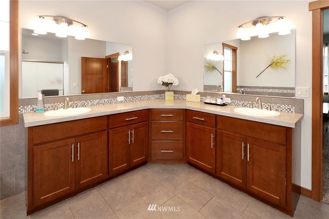 804 Red Maple Loop Everson, WA 98247 - Photo 25 of 40 a bathroom with a granite countertop sink double and mirror