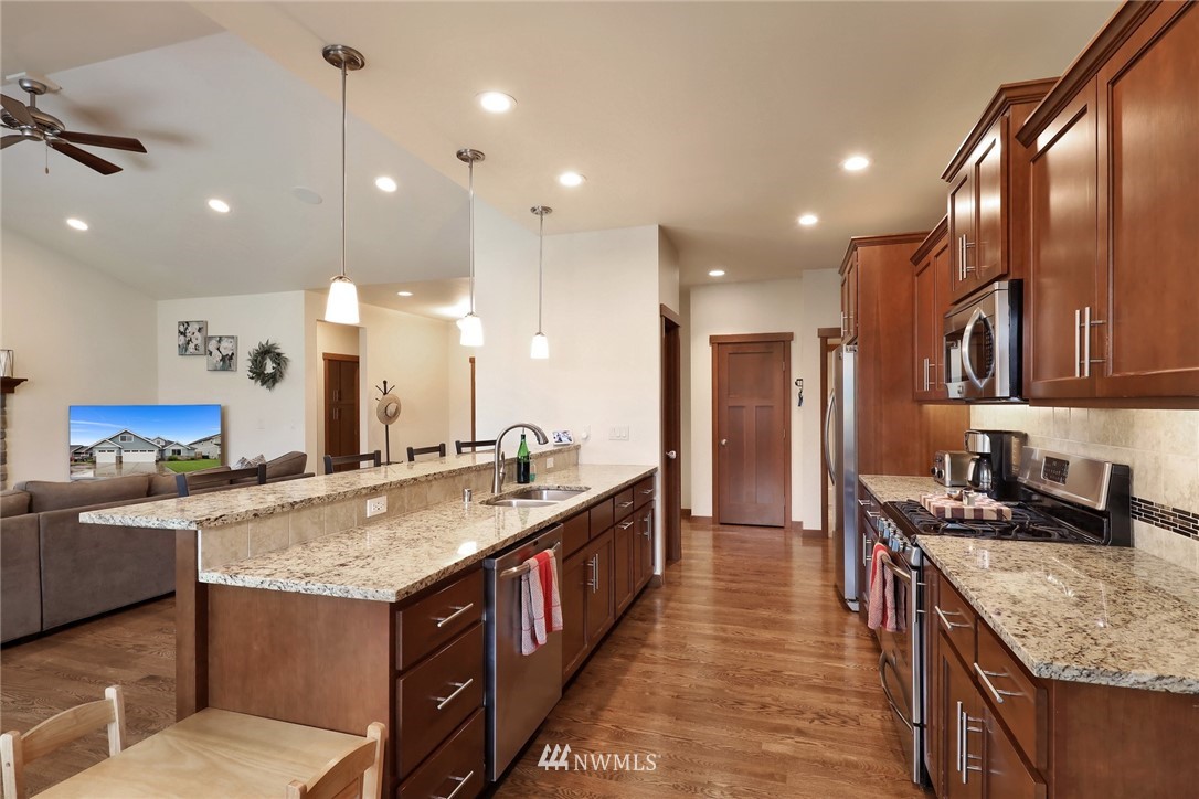 804 Red Maple Loop Everson, WA 98247 - Photo 7 of 40 a kitchen with stainless steel appliances granite countertop a sink stove and refrigerator