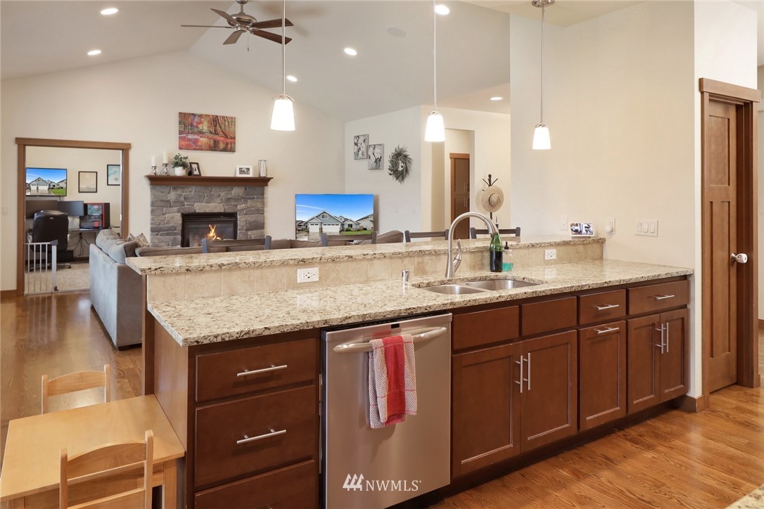 804 Red Maple Loop Everson, WA 98247 - Photo 8 of 40 a kitchen with granite countertop a sink a counter space appliances and cabinets