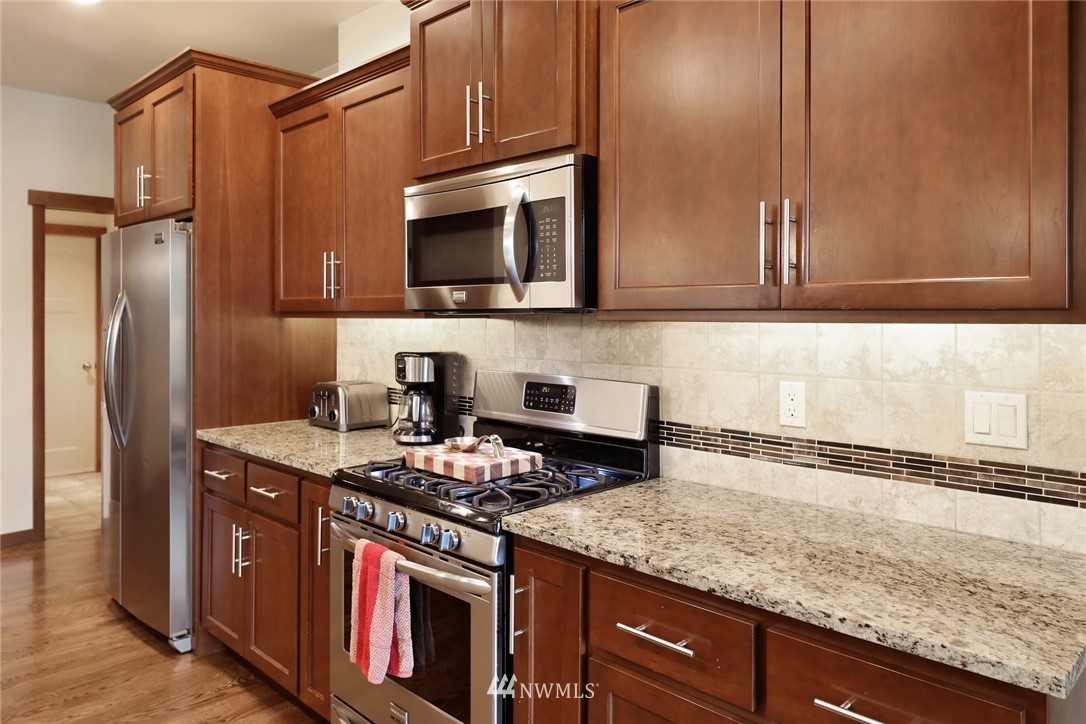 804 Red Maple Loop Everson, WA 98247 - Photo 9 of 40 a kitchen with stainless steel appliances granite countertop a stove a sink and a microwave