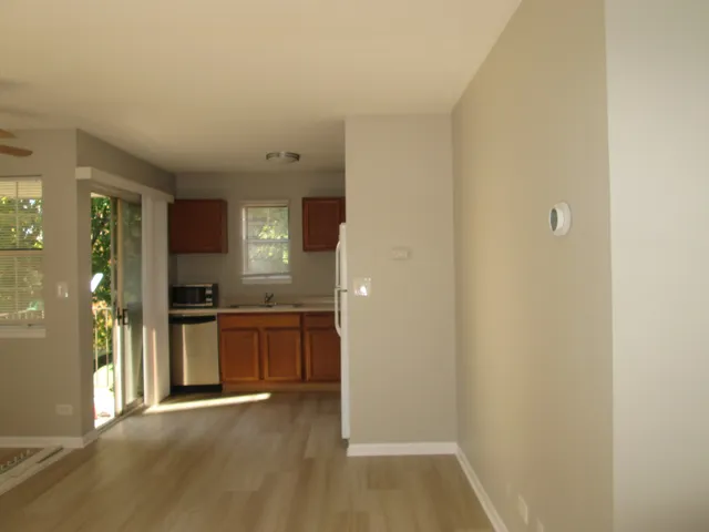 a kitchen with a sink cabinets and a window