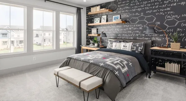 a bedroom with a bed and a potted plant