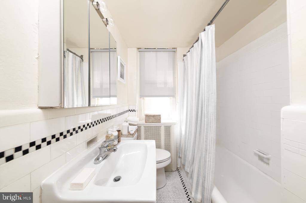 2100-02 Walnut Street, Unit 2M Philadelphia, PA 19103 - Photo 2 of 15 a bathroom with a sink a toilet and a bathtub