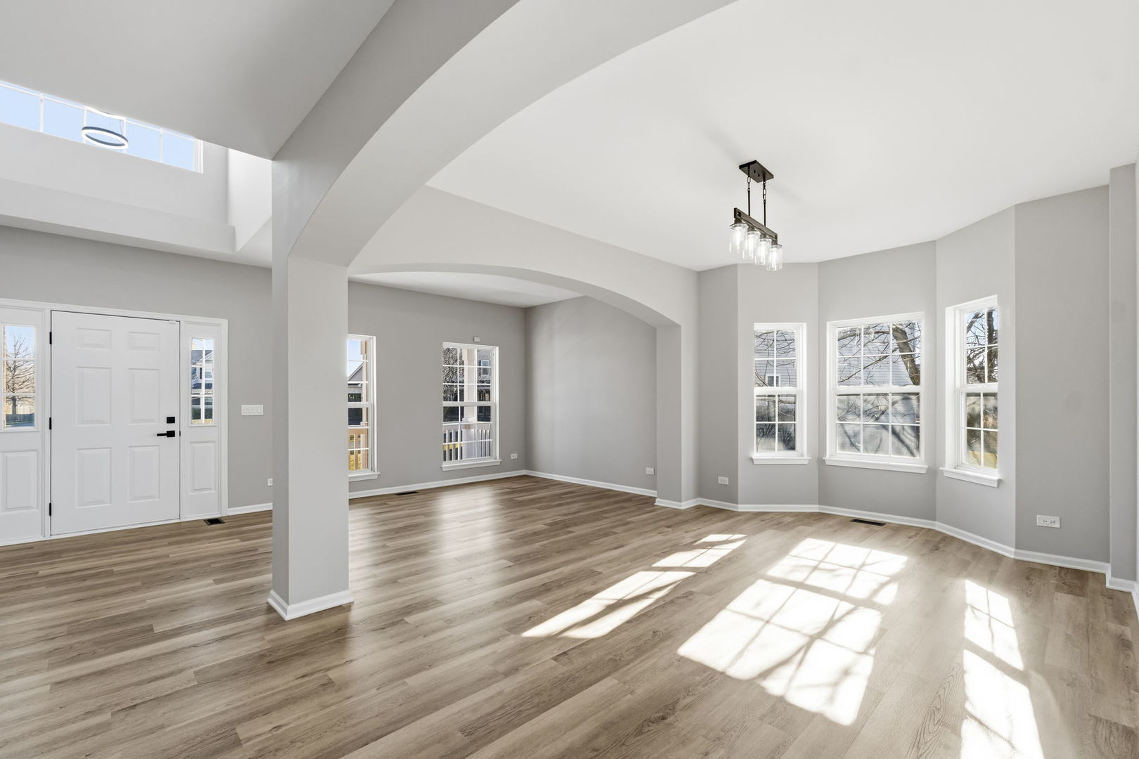 22718 Bass Lake Road Plainfield, IL 60544 - Photo 2 of 15 a view of an empty room with wooden floor and a window