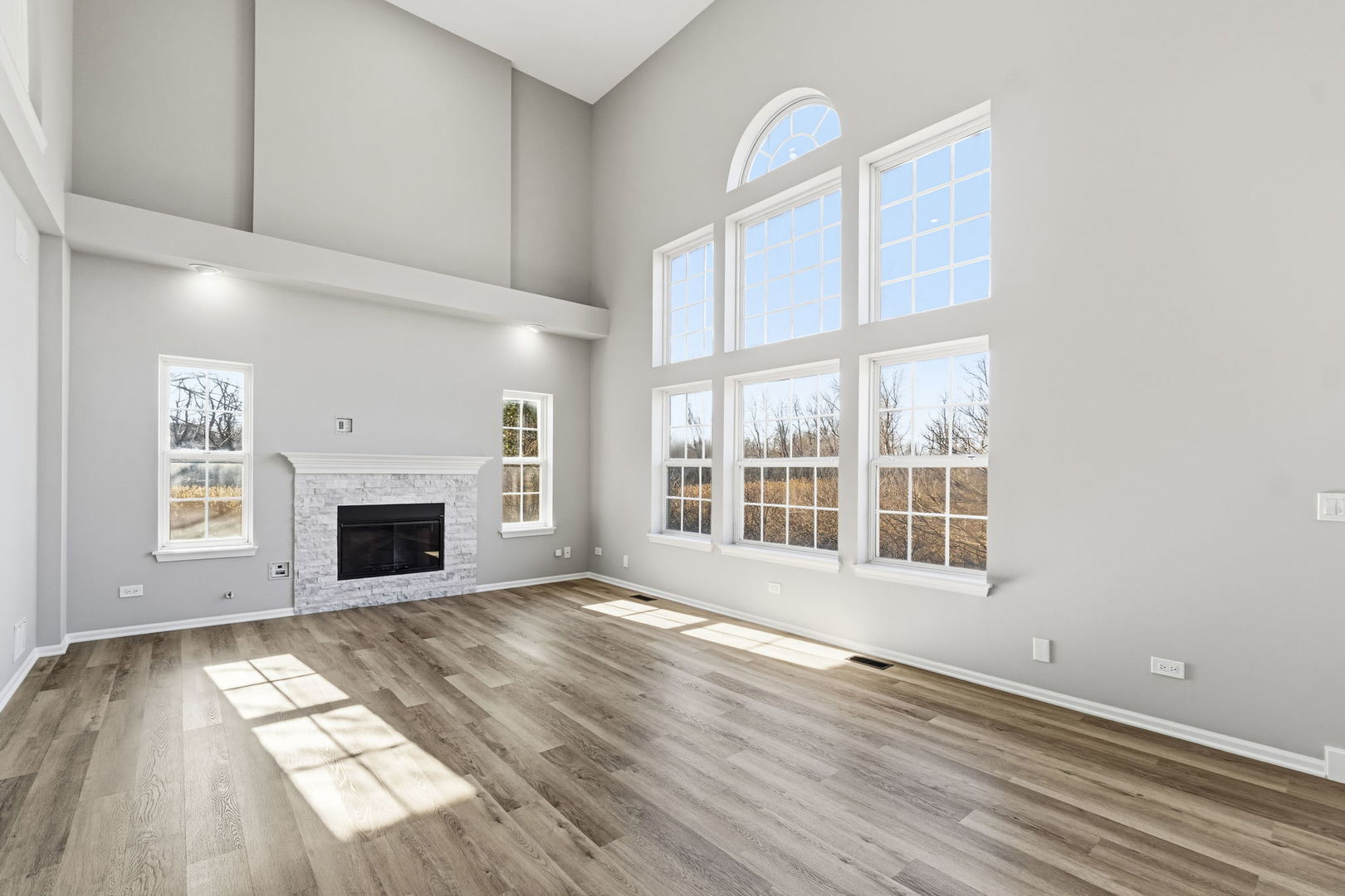 22718 Bass Lake Road Plainfield, IL 60544 - Photo 3 of 15 a view of empty room with wooden floor and fireplace