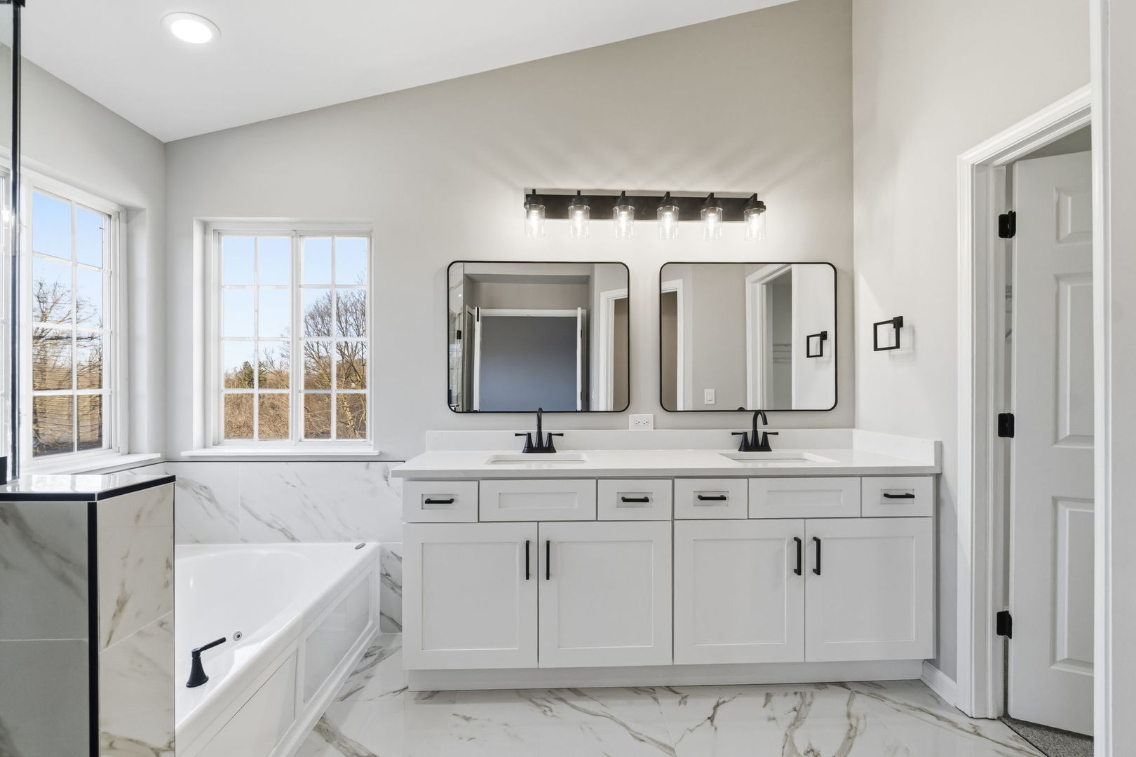 22718 Bass Lake Road Plainfield, IL 60544 - Photo 8 of 15 a bathroom with a double vanity sink mirror and bathtub
