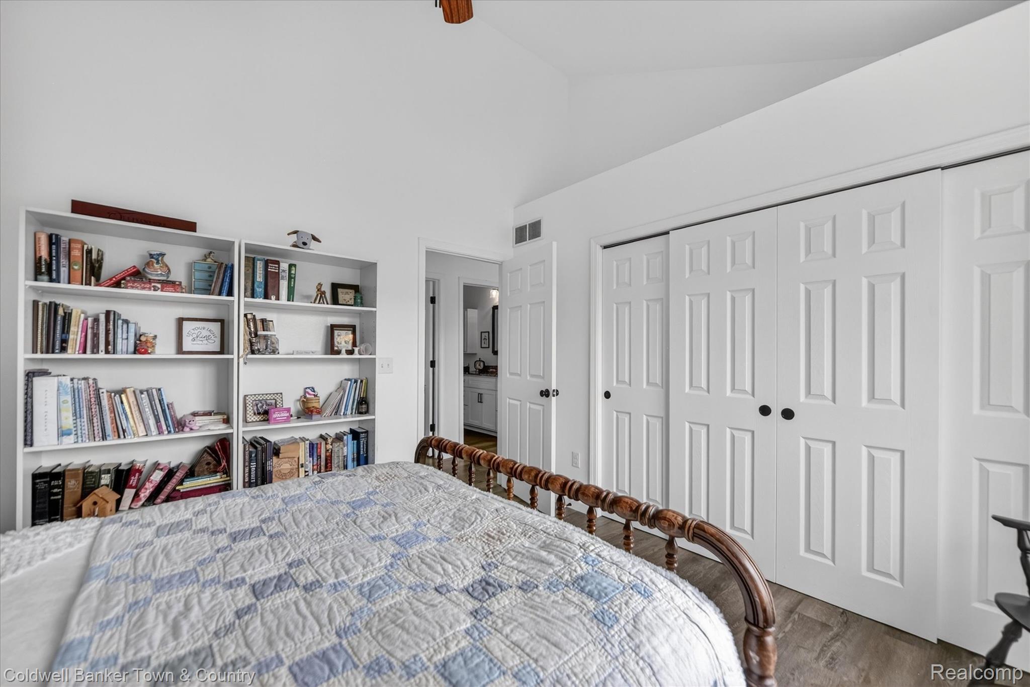918 Gray Fox Court Howell, MI 48843 - Photo 58 of 84 Bright interior space featuring white walls, vaulted ceiling, and wood-finish flooring