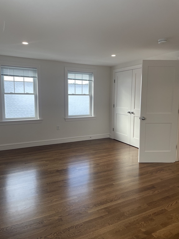 29 Crescent Road, Unit 29 Belmont, MA 02478 - Photo 17 of 21 an empty room with wooden floor and windows