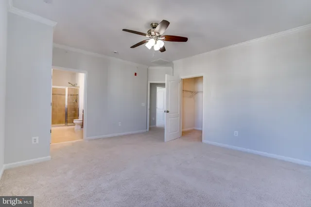 a spacious bathroom with a granite countertop sink toilet a large mirror a shower and a bathtub