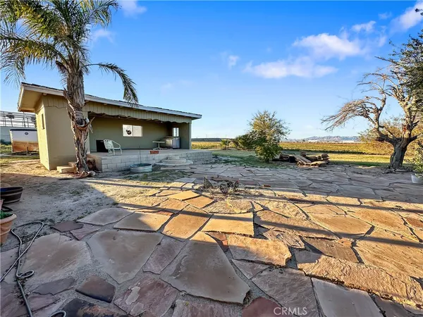 a view of a house with pool and sitting area