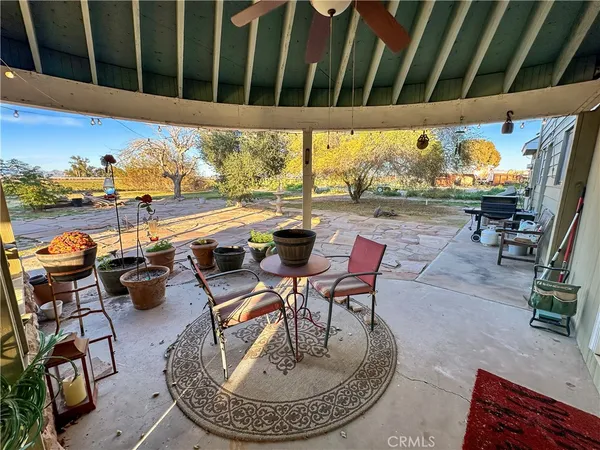 a view of a chairs and table in patio