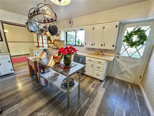 a kitchen with a sink microwave and cabinets