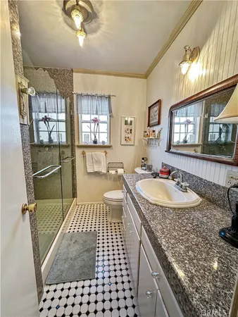a bathroom with a sink a granite counter tops and a window