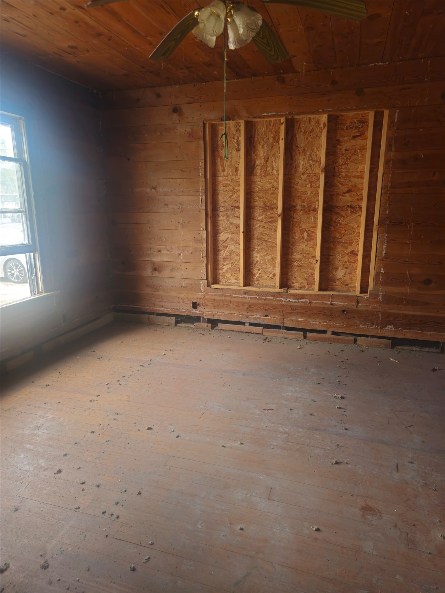 507 Merchant Street El Campo, TX 77437 - Photo 27 of 33 an empty room with wooden floor and windows