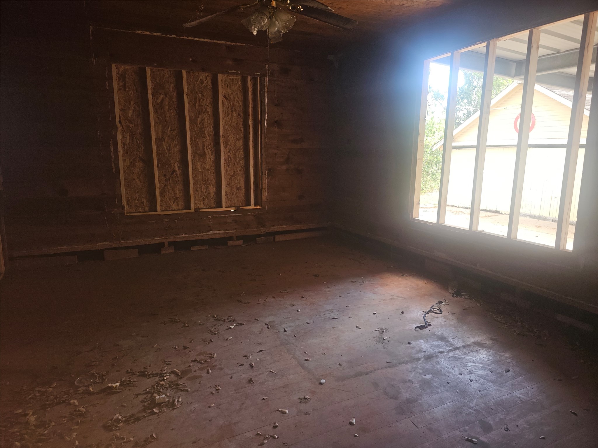 507 Merchant Street El Campo, TX 77437 - Photo 30 of 33 an empty room with wooden floor and windows