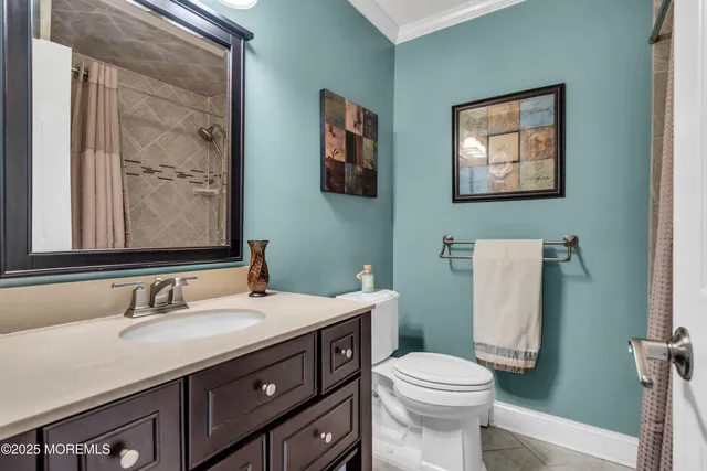 a bathroom with a sink vanity mirror and toilet