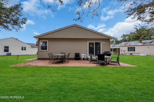 a view of a house with backyard porch and sitting area