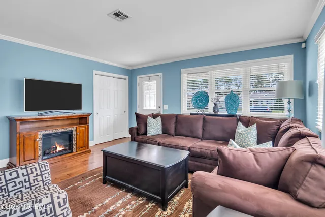 a living room with furniture fireplace and flat screen tv