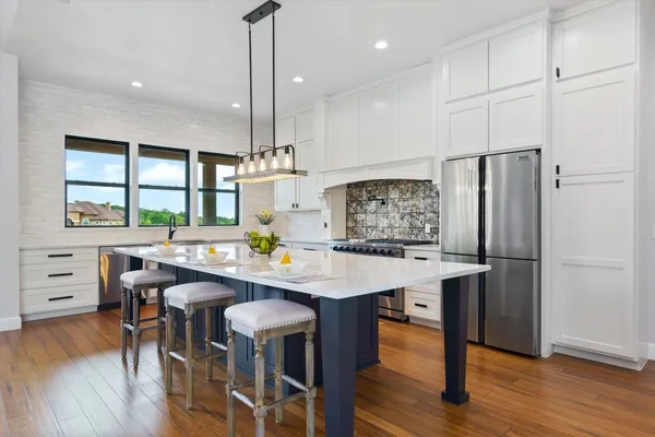 a view of a kitchen with a table and chairs
