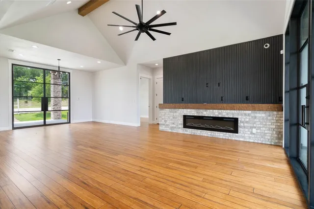 a kitchen with stainless steel appliances kitchen island granite countertop a sink stove and wooden floor