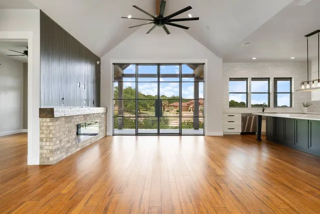 a kitchen with stainless steel appliances granite countertop a stove and wooden floor