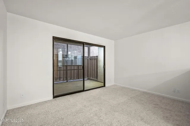 an empty room with sliding glass door