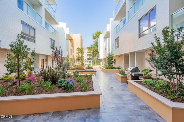 a view of a patio with couches and potted plants