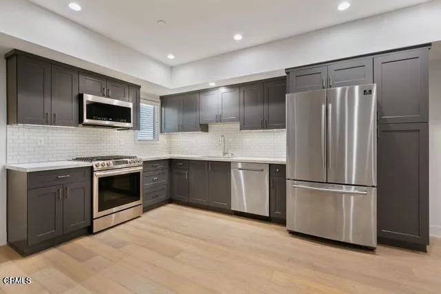 a view of kitchen with a sink and a refrigerator