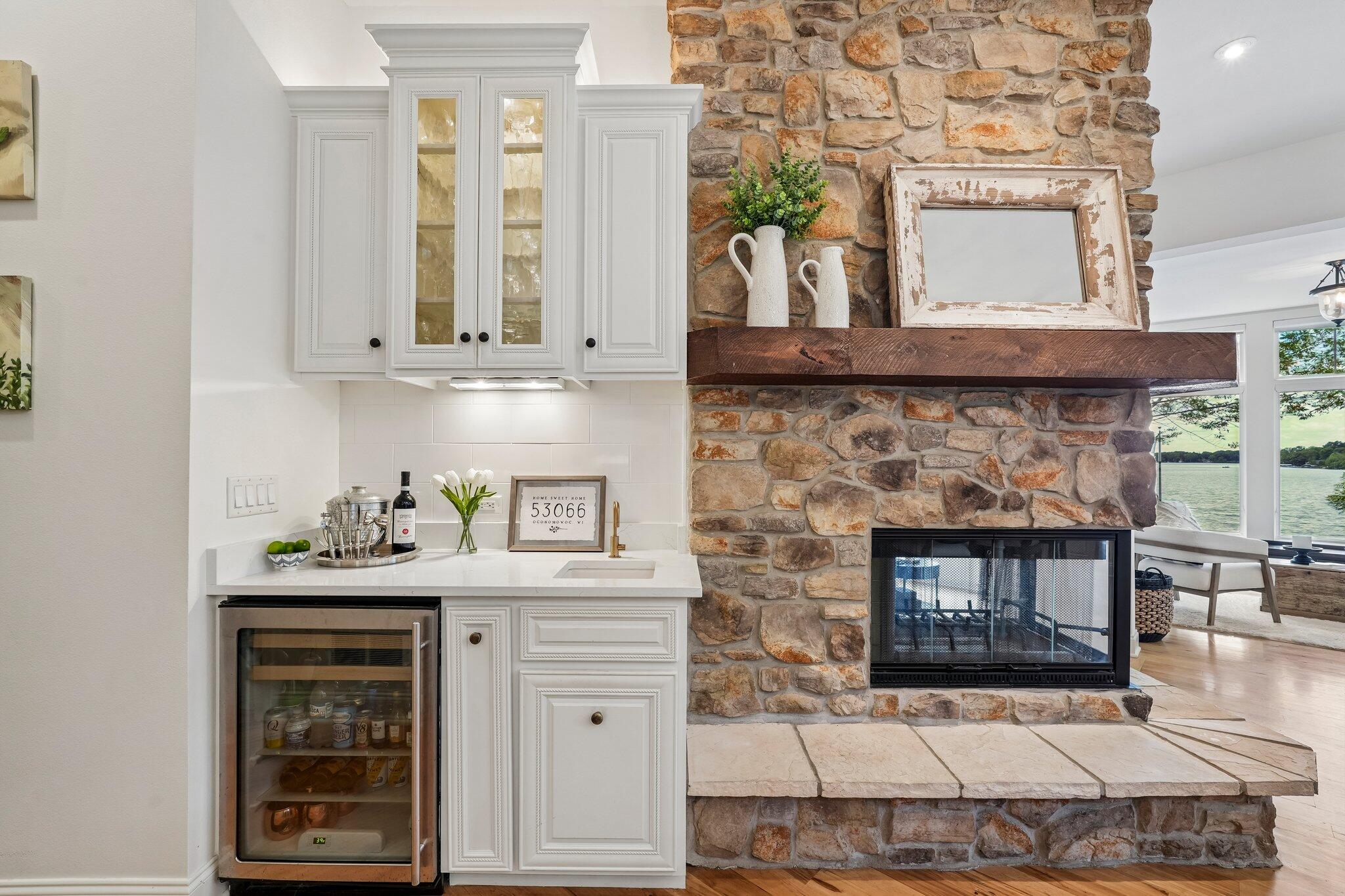 W343N6293 South Bayview Road Oconomowoc, WI 53066 - Photo 42 of 104 Wet bar and two sided fireplace